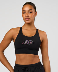 Woman wearing Accelerate Graphic Sports Bra - Black-Radiate | Model:Rosie | Size:S | Thumbnail Index: 2
