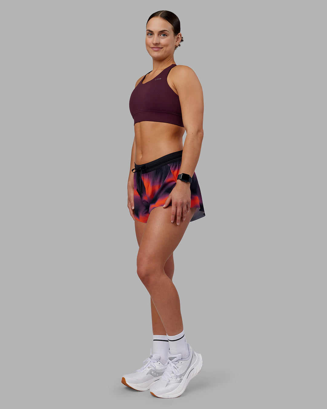 Woman wearing Accelerate Split Strap Sports Bra - Cherry Lacquer | Model:Keisha | Size:S - view 3
