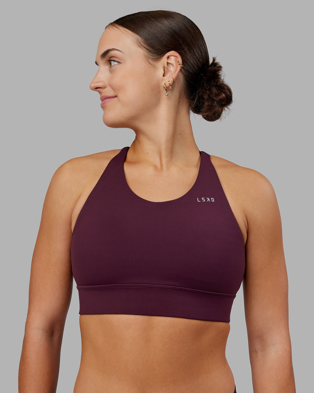 Woman wearing Accelerate Split Strap Sports Bra - Cherry Lacquer | Model:Keisha | Size:S - view 1