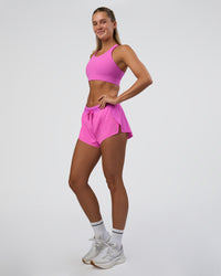 Woman wearing Accelerate Split Strap Sports Bra - Ultra Fuchsia | Model:Amity | Size:S | Thumbnail Index: 4