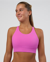 Woman wearing Accelerate Split Strap Sports Bra - Ultra Fuchsia | Model:Amity | Size:S | Thumbnail Index: 0