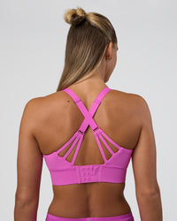 Woman wearing Accelerate Split Strap Sports Bra - Ultra Fuchsia | Model:Amity | Size:S | Thumbnail Index: 1
