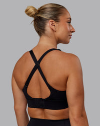 Woman wearing Accelerate Sports Bra - Black | Set:true | Angle:back | Model:Lyss | Size:S | Thumbnail Index: 5