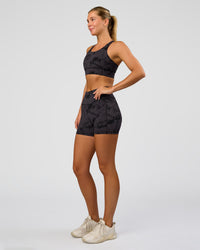 Woman wearing Accelerate Sports Bra - Black Tie Dye | Model:Amity | Size:S | Thumbnail Index: 2