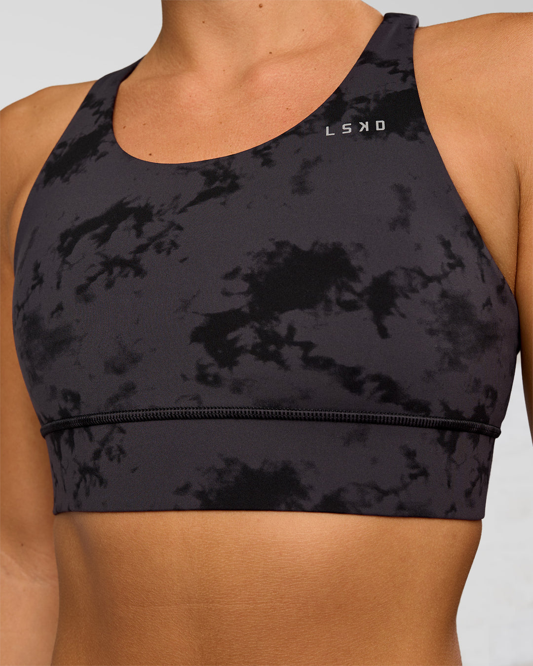 Woman wearing Accelerate Sports Bra - Black Tie Dye | Set:true | Angle:closeup | Model:Amity | Size:S - view 4