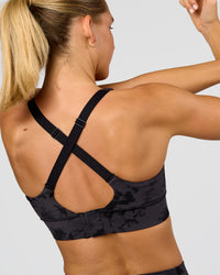 Woman wearing Accelerate Sports Bra - Black Tie Dye | Model:Amity | Size:S | Thumbnail Index: 1