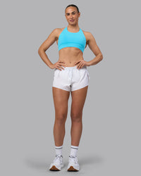 Woman wearing Accelerate Sports Bra - Blue Atoll | Model:Sophie | Size:S | Thumbnail Index: 5
