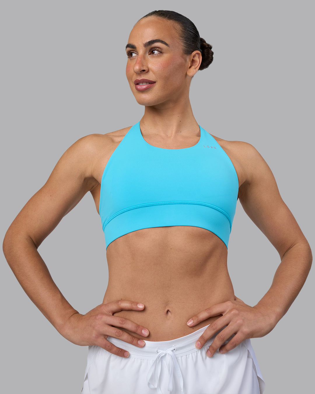 Woman wearing Accelerate Sports Bra - Blue Atoll | Set:true | Angle:front | Model:Sophie | Size:S - view 5