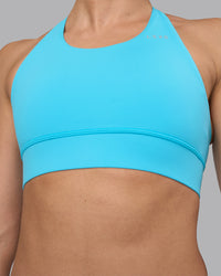 Woman wearing Accelerate Sports Bra - Blue Atoll | Set:true | Angle:closeup | Model:Sophie | Size:S | Thumbnail Index: 6
