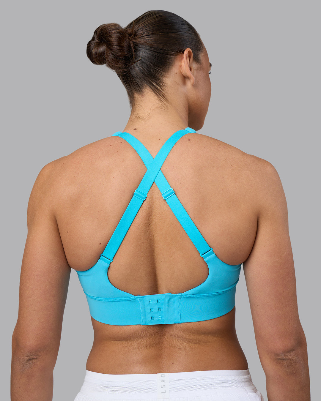 Woman wearing Accelerate Sports Bra - Blue Atoll | Set:true | Angle:back | Model:Sophie | Size:S - view 8