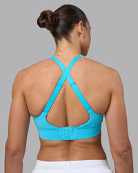 Woman wearing Accelerate Sports Bra - Blue Atoll | Set:true | Angle:back | Model:Sophie | Size:S | Thumbnail Index: 7