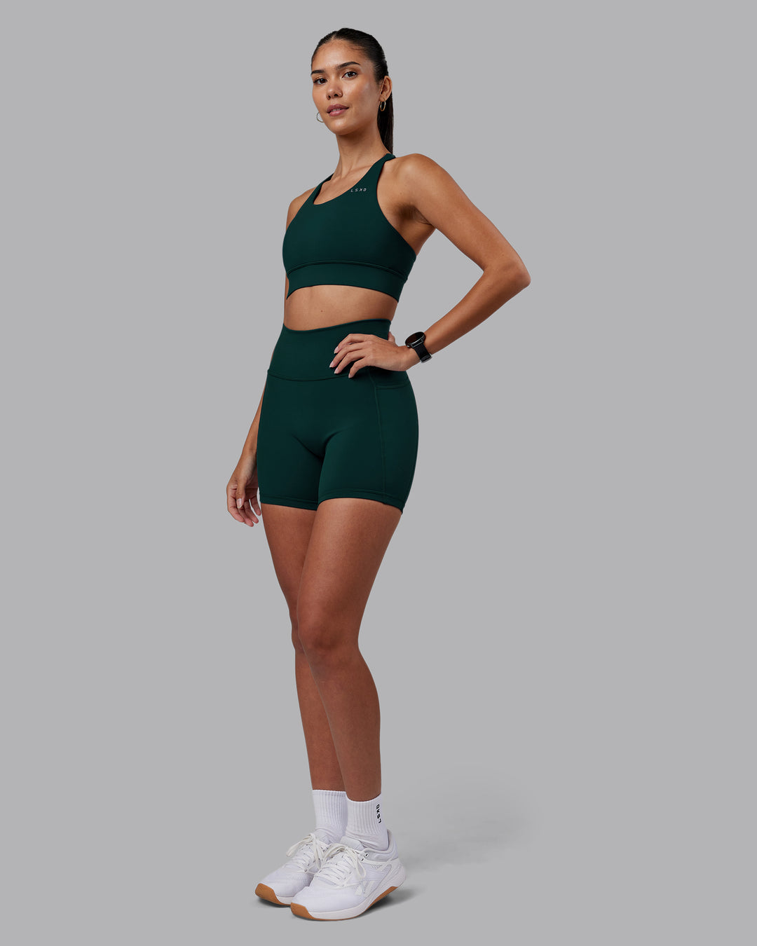 Woman wearing Accelerate Sports Bra - Dark Moss | Model:Rhiley | Size:S - view 8