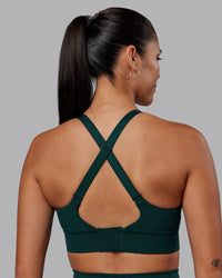 Woman wearing Accelerate Sports Bra - Dark Moss | Set:true | Angle:back | Model:Rhiley | Size:S | Thumbnail Index: 5
