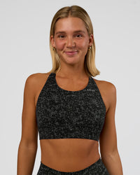 Woman wearing Accelerate Sports Bra - Energy Print Black | Set:true | Angle:front | Model:Amity | Size:S | Thumbnail Index: 0