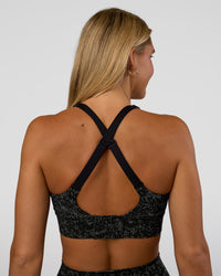 Woman wearing Accelerate Sports Bra - Energy Print Black | Set:true | Angle:back | Model:Amity | Size:S | Thumbnail Index: 1