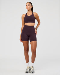 Woman wearing Accelerate Sports Bra - Midnight Plum | Model:Rhiley | Size:S | Thumbnail Index: 2