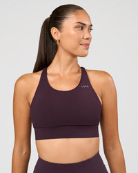 Woman wearing Accelerate Sports Bra - Midnight Plum | Set:true | Angle:front | Model:Rhiley | Size:S | Thumbnail Index: 0