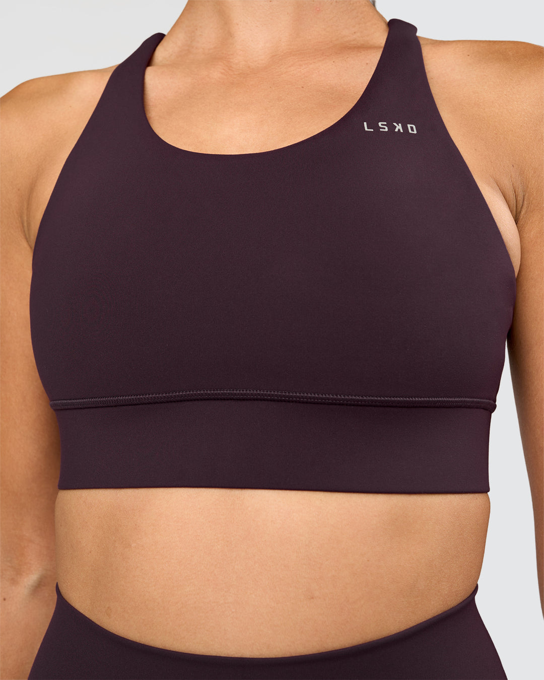 Woman wearing Accelerate Sports Bra - Midnight Plum | Set:true | Angle:closeup | Model:Rhiley | Size:S - view 4