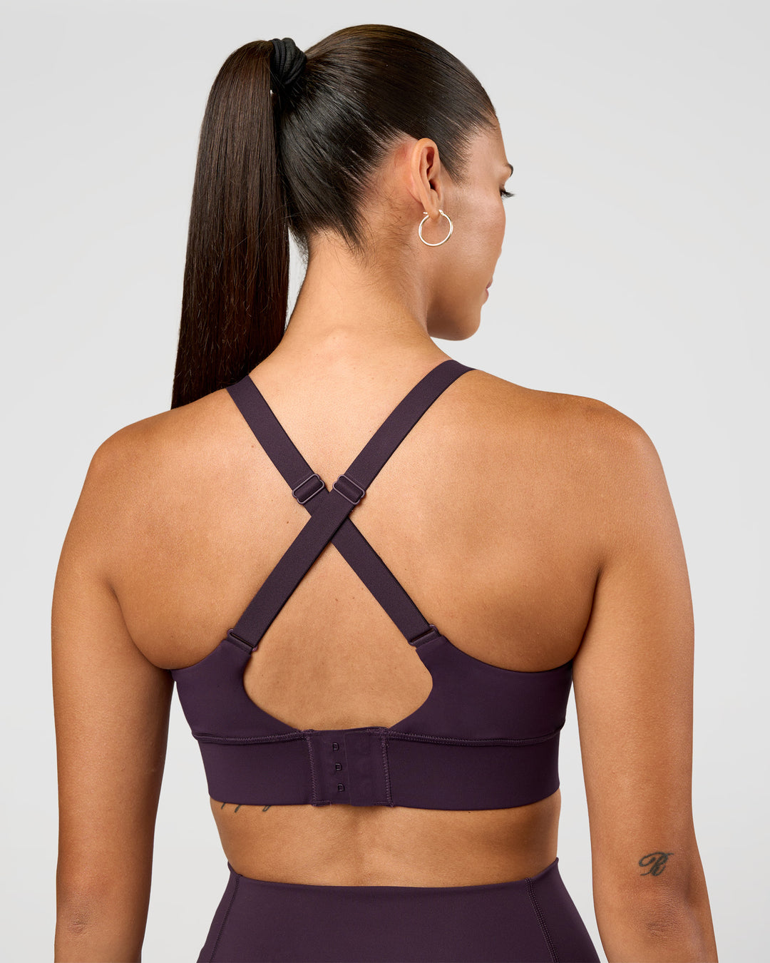 Woman wearing Accelerate Sports Bra - Midnight Plum | Set:true | Angle:back | Model:Rhiley | Size:S - view 2