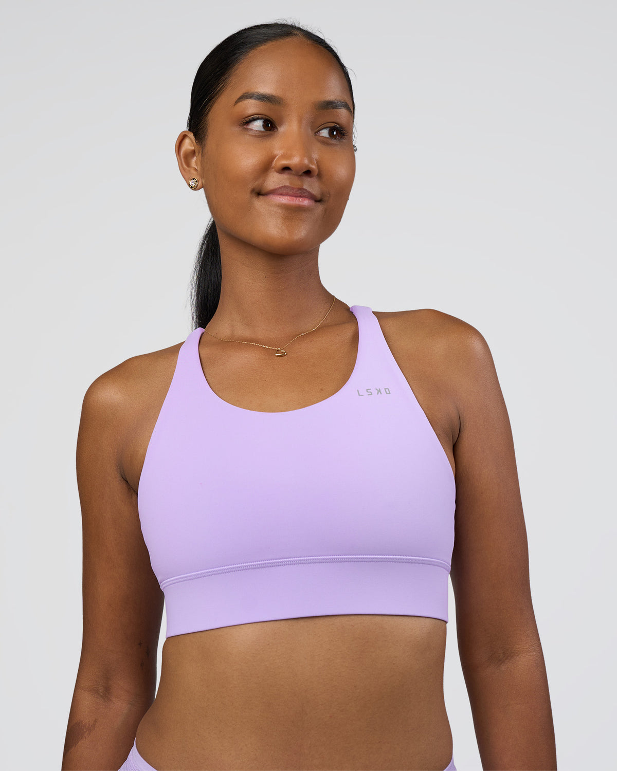 Woman wearing Accelerate Sports Bra - Pale Lilac | Set:true | Angle:front | Model:Rica | Size:S