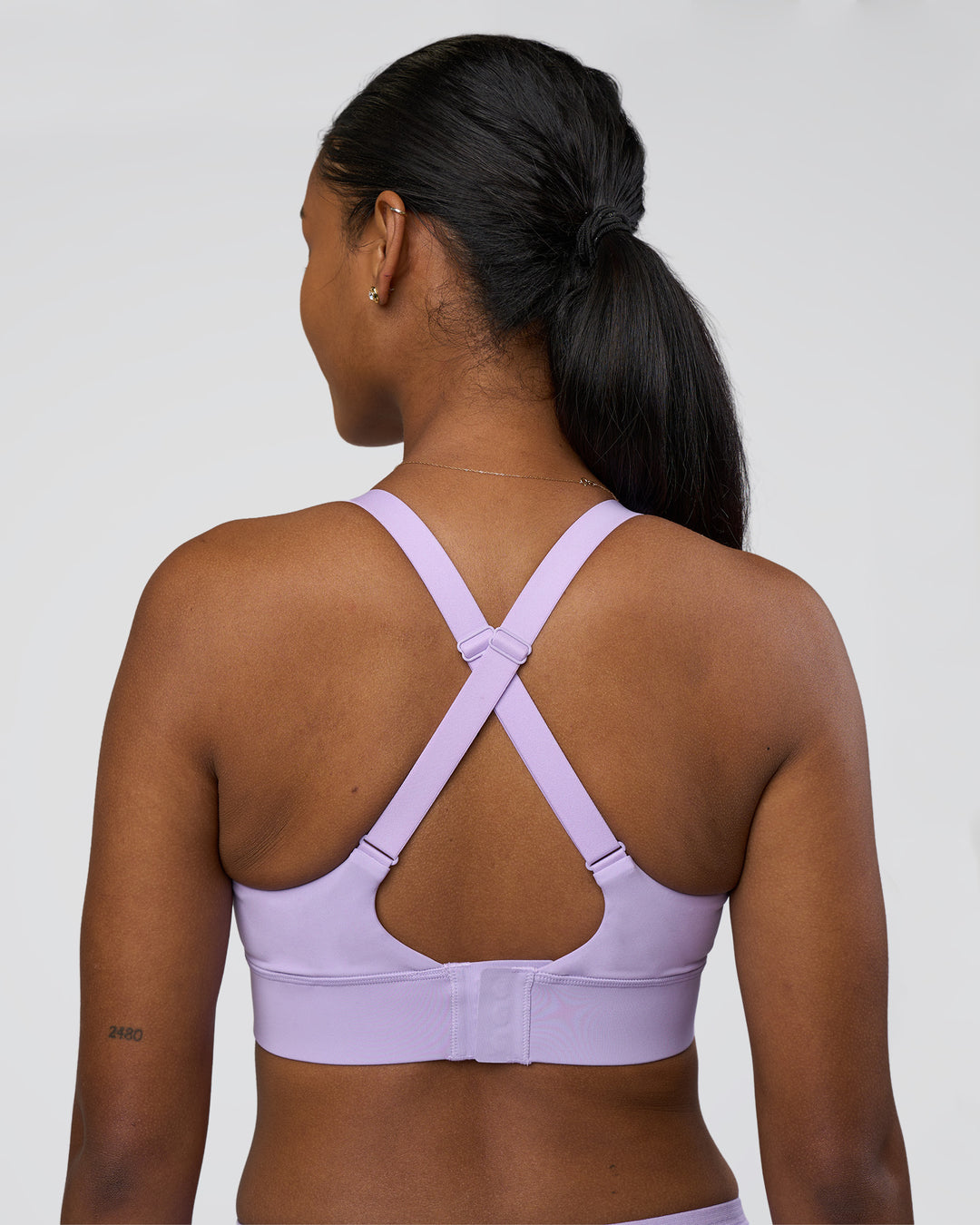 Woman wearing Accelerate Sports Bra - Pale Lilac | Set:true | Angle:back | Model:Rica | Size:S - view 2