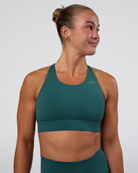 Woman wearing Accelerate Sports Bra - Transformative Teal | Set:true | Angle:front | Model:Sav | Size:S | Thumbnail Index: 0