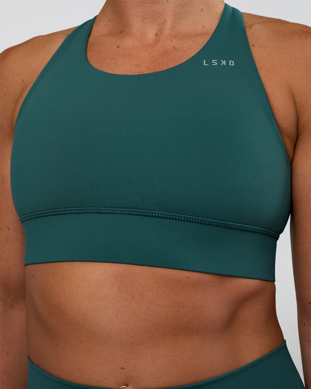 Woman wearing Accelerate Sports Bra - Transformative Teal | Set:true | Angle:closeup | Model:Sav | Size:S - view 4