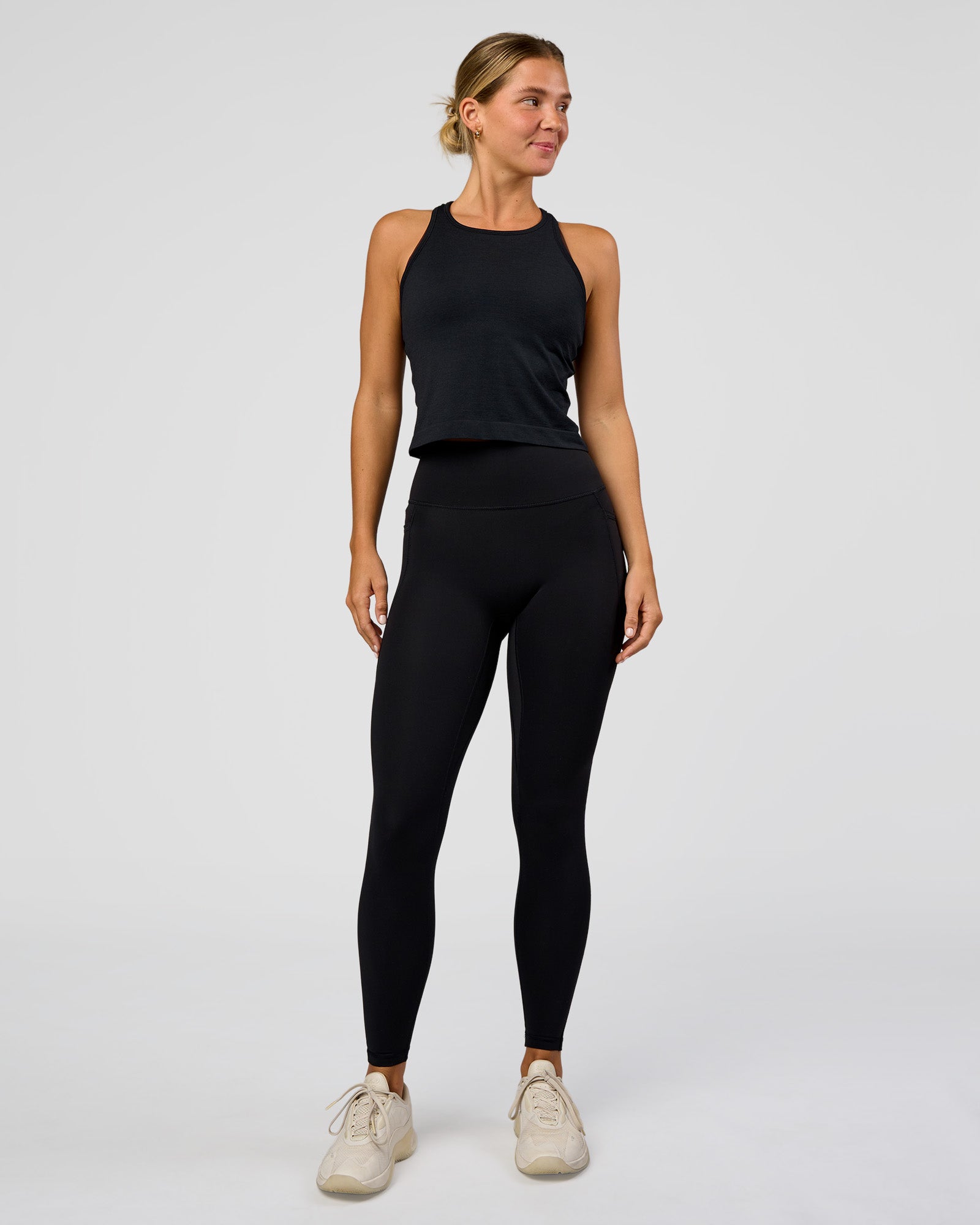 Woman wearing AeroFLX+ Seamless Flow Skimmer Tank - Black Marl | Model:Amity | Size:S