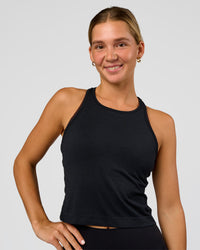 Woman wearing AeroFLX+ Seamless Flow Skimmer Tank - Black Marl | Model:Amity | Size:S | Thumbnail Index: 0