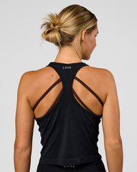 Woman wearing AeroFLX+ Seamless Flow Skimmer Tank - Black Marl | Model:Amity | Size:S | Thumbnail Index: 2