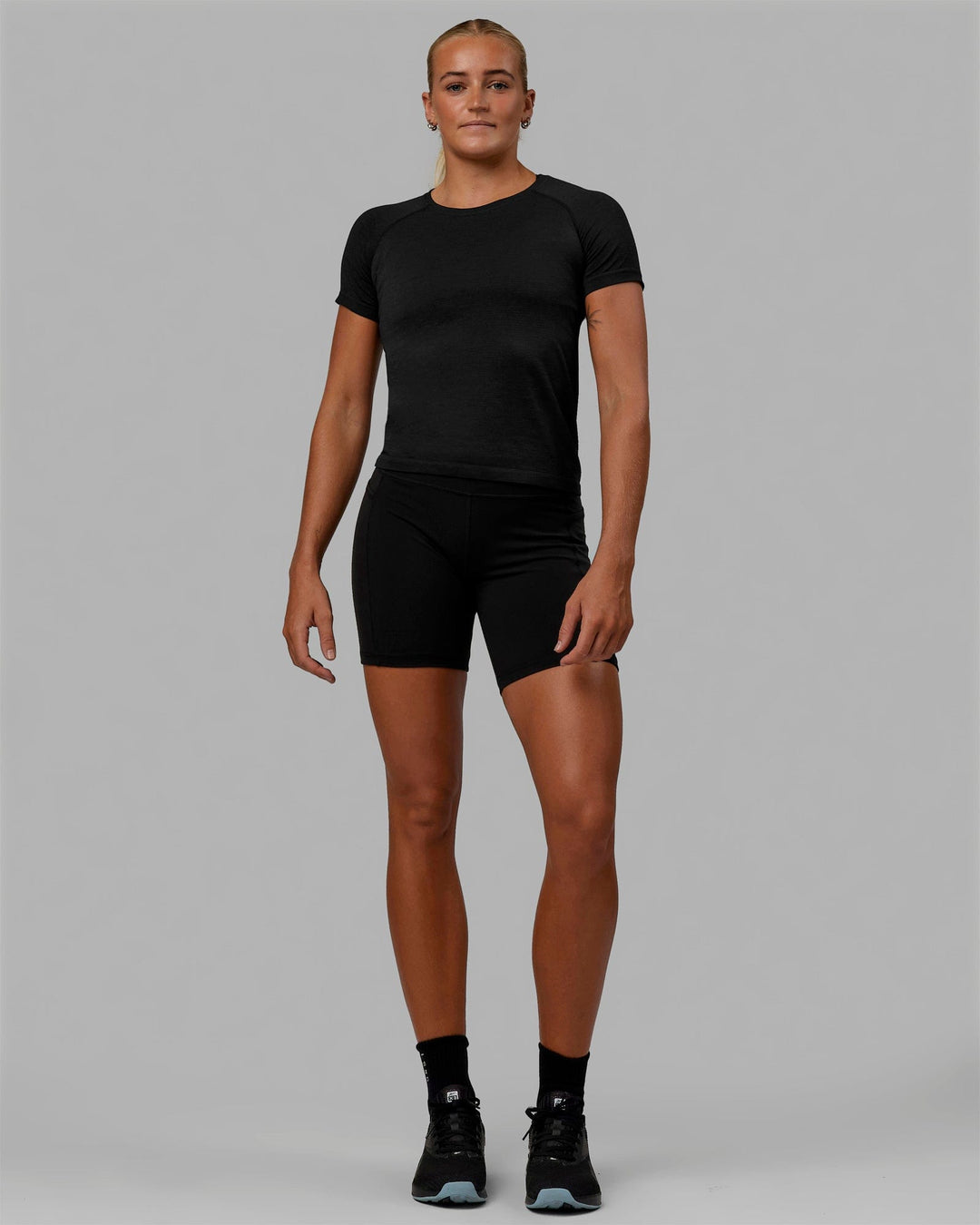 Woman wearing AeroFLX+ Seamless Tee - Black Marl - view 8