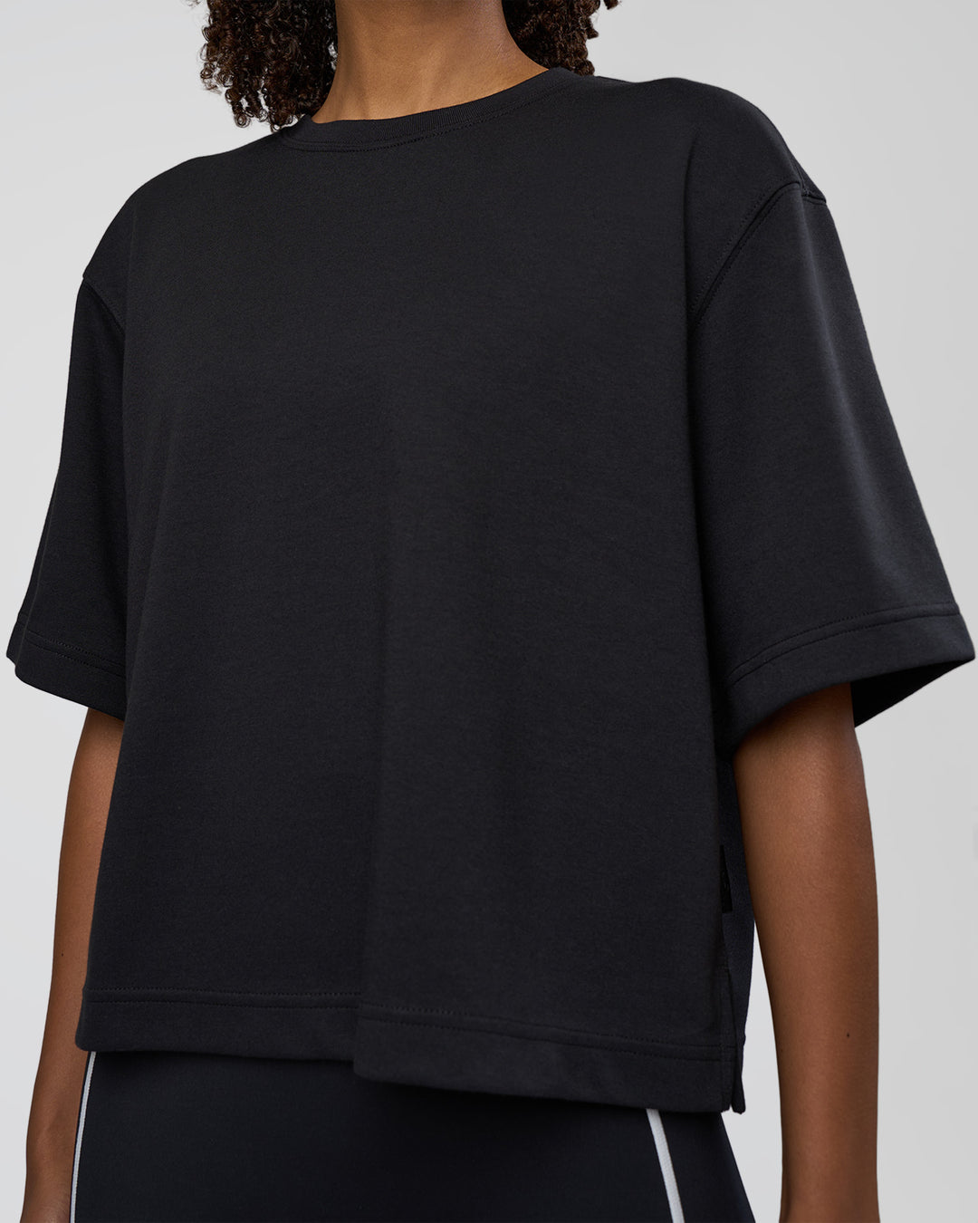 Woman wearing AfterDark ZeroCrease Cropped Tee - Black | Model:Tomi | Size:S - view 7