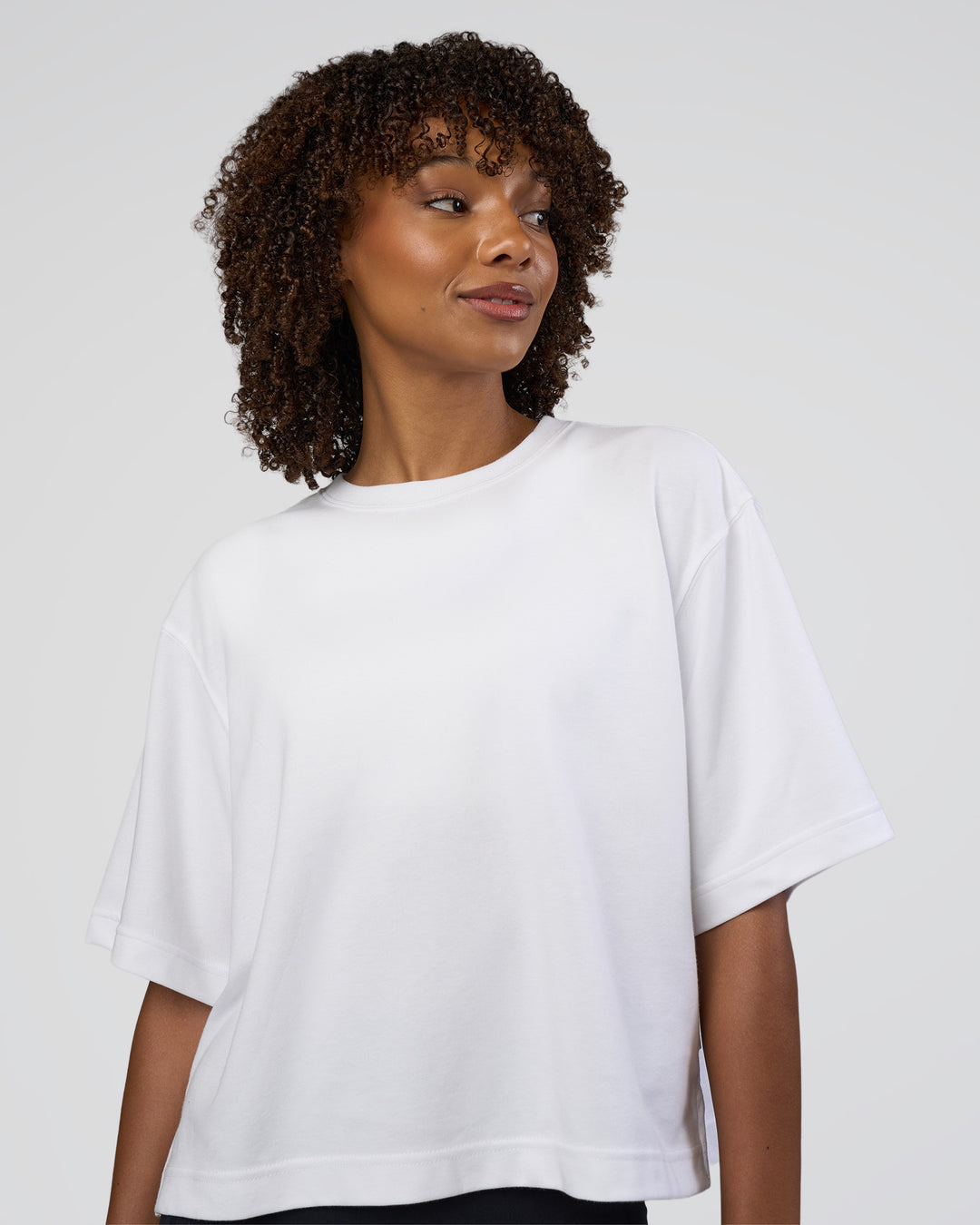 Woman wearing AfterDark ZeroCrease Cropped Tee - White | Model:Tomi | Size:S - view 1