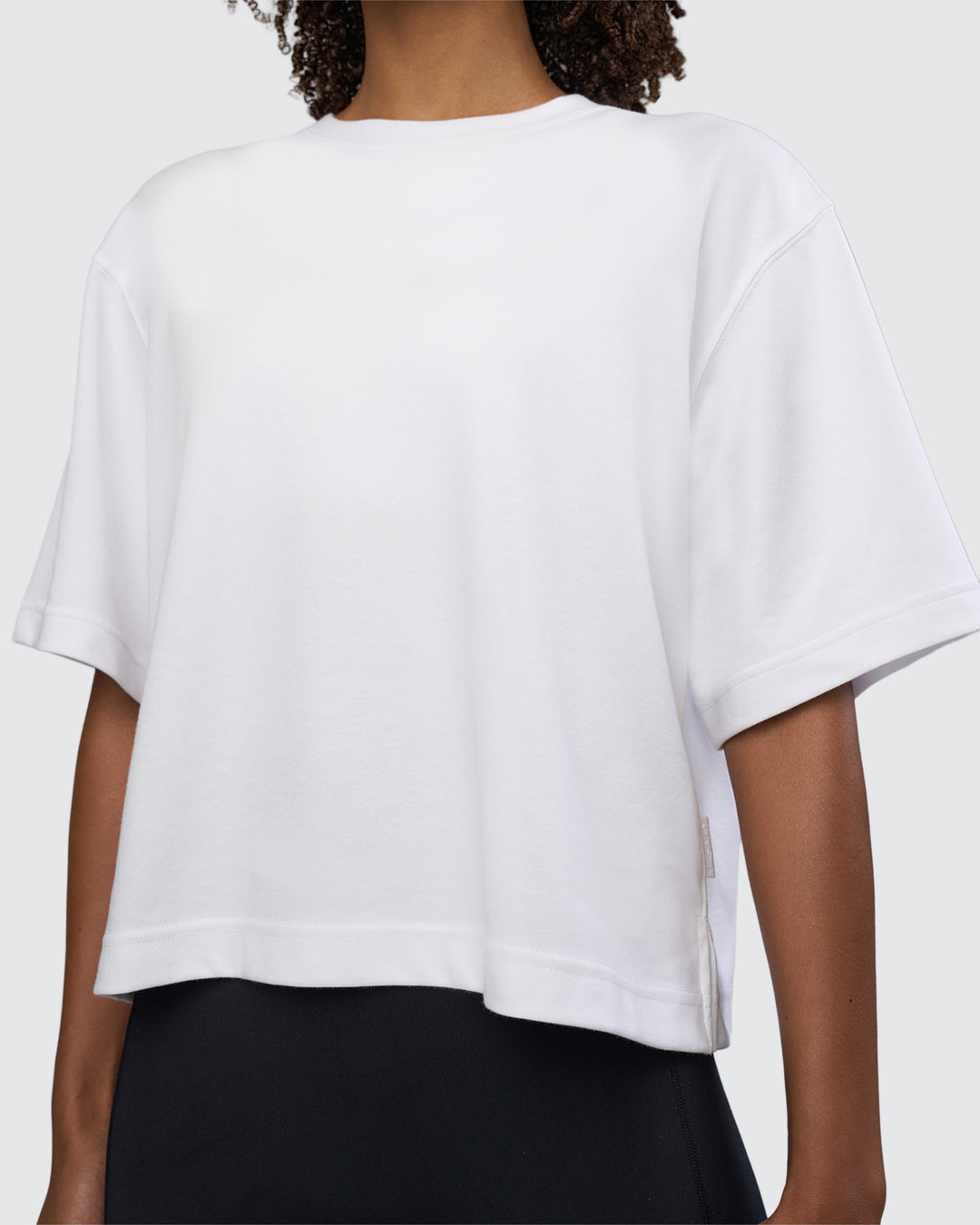 Woman wearing AfterDark ZeroCrease Cropped Tee - White | Model:Tomi | Size:S - view 7