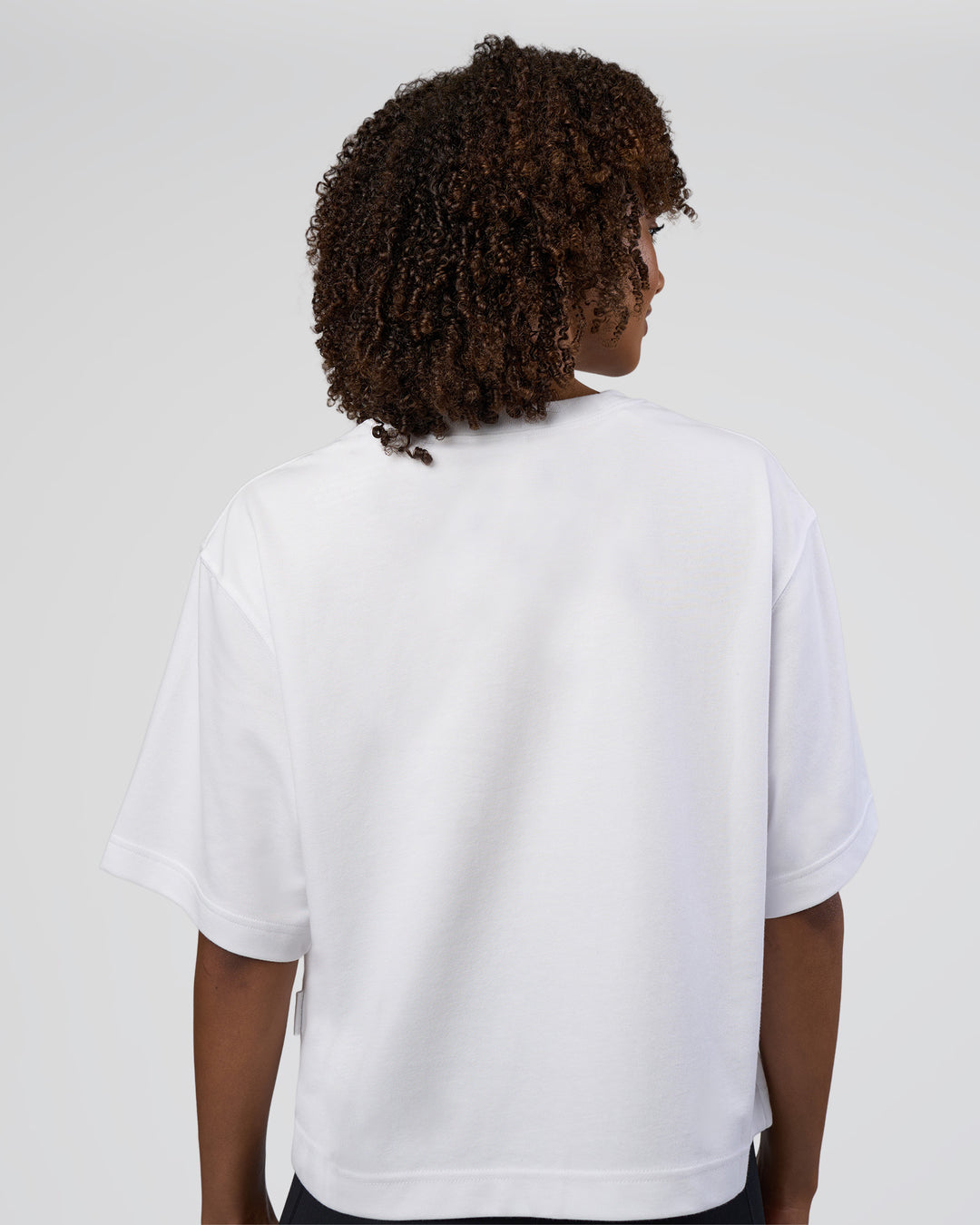 Woman wearing AfterDark ZeroCrease Cropped Tee - White | Model:Tomi | Size:S - view 4