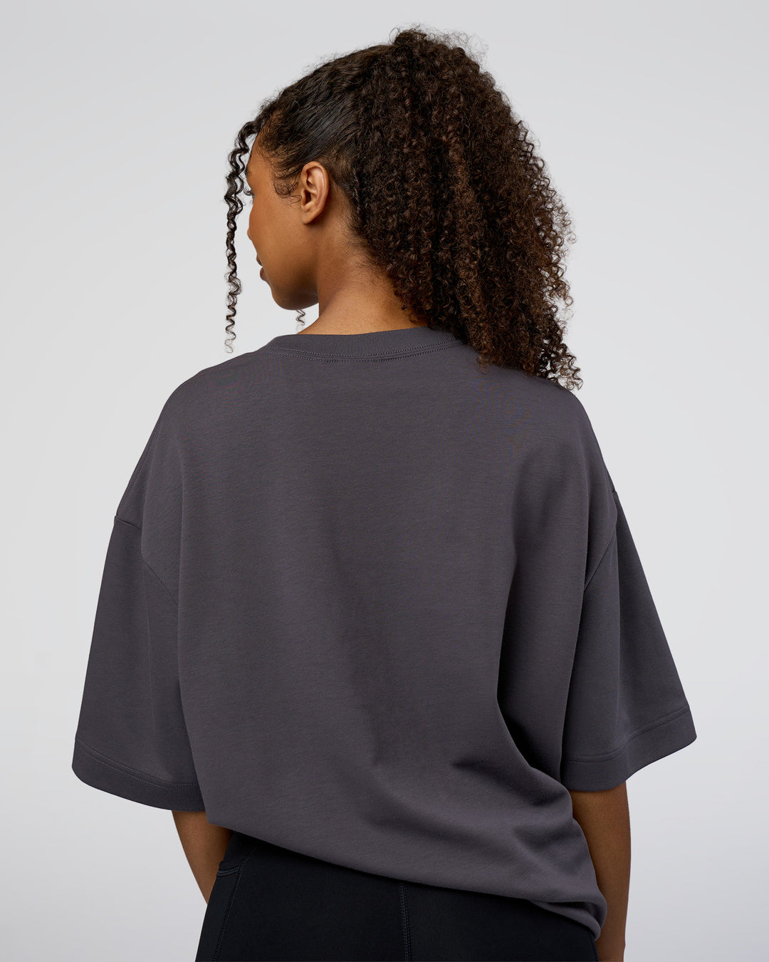 Woman wearing AfterDark ZeroCrease Oversized Tee - Dark Storm | Model:Jordan | Size:S - view 7
