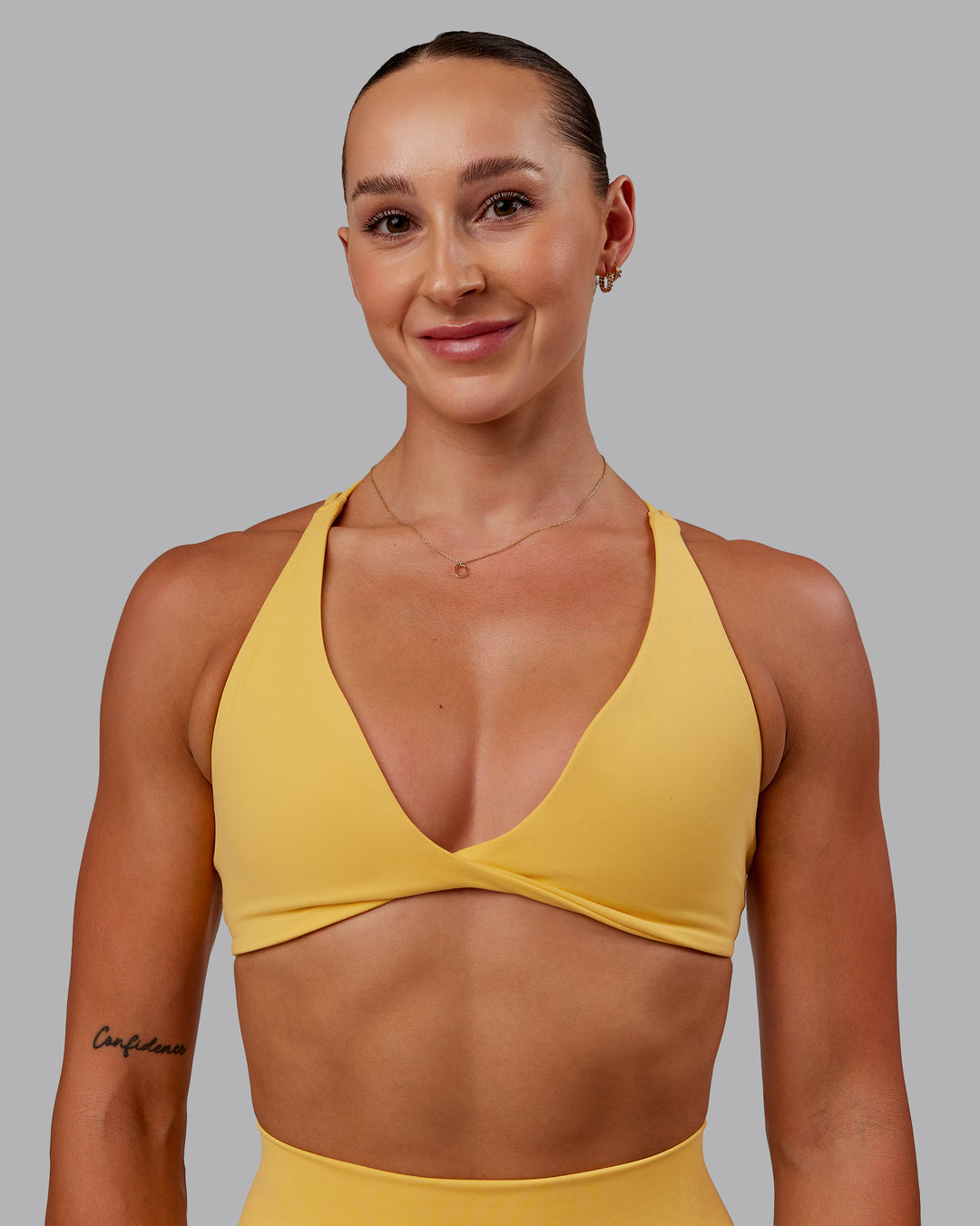 Woman wearing Agile Sports Bra in Banana Cream | Size:S - view 1