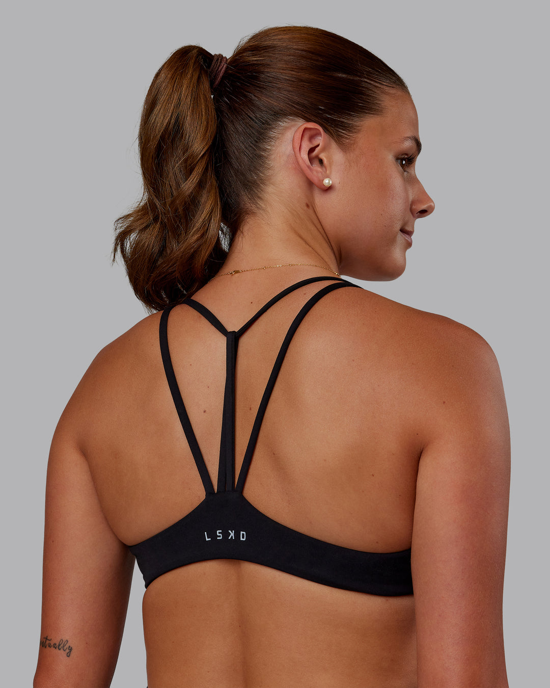 Woman wearing Agile Sports Bra - Black| Model:Phoebe | Size:S - view 1