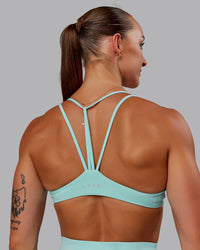 Woman wearing Agile Sports Bra in Island Paradise | Size:S | Thumbnail Index: 0