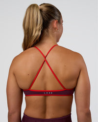 Woman wearing Ambience Sports Bra - Cherry Lacquer-Flame | Model:Sav | Size:S | Thumbnail Index: 0