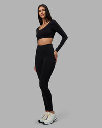 Woman wearing Aria Long Sleeve Sports Bra - Black | Model:Rhiley | Size:S | Thumbnail Index: 2