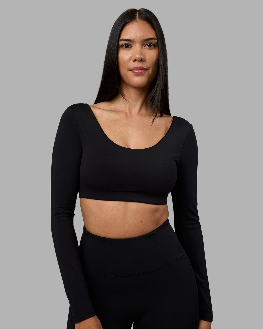 Woman wearing Aria Long Sleeve Sports Bra - Black | Model:Rhiley | Size:S - view 1