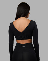 Woman wearing Aria Long Sleeve Sports Bra - Black | Model:Rhiley | Size:S | Thumbnail Index: 1