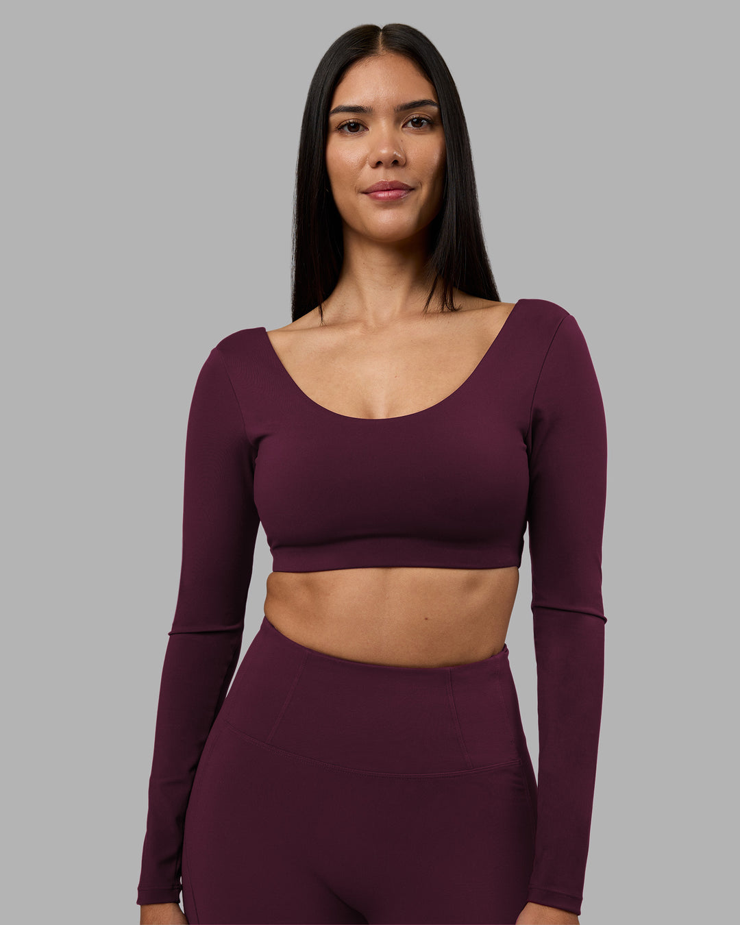 Woman wearing Aria Long Sleeve Sports Bra - Cherry Lacquer | Model:Rhiley | Size:S - view 1