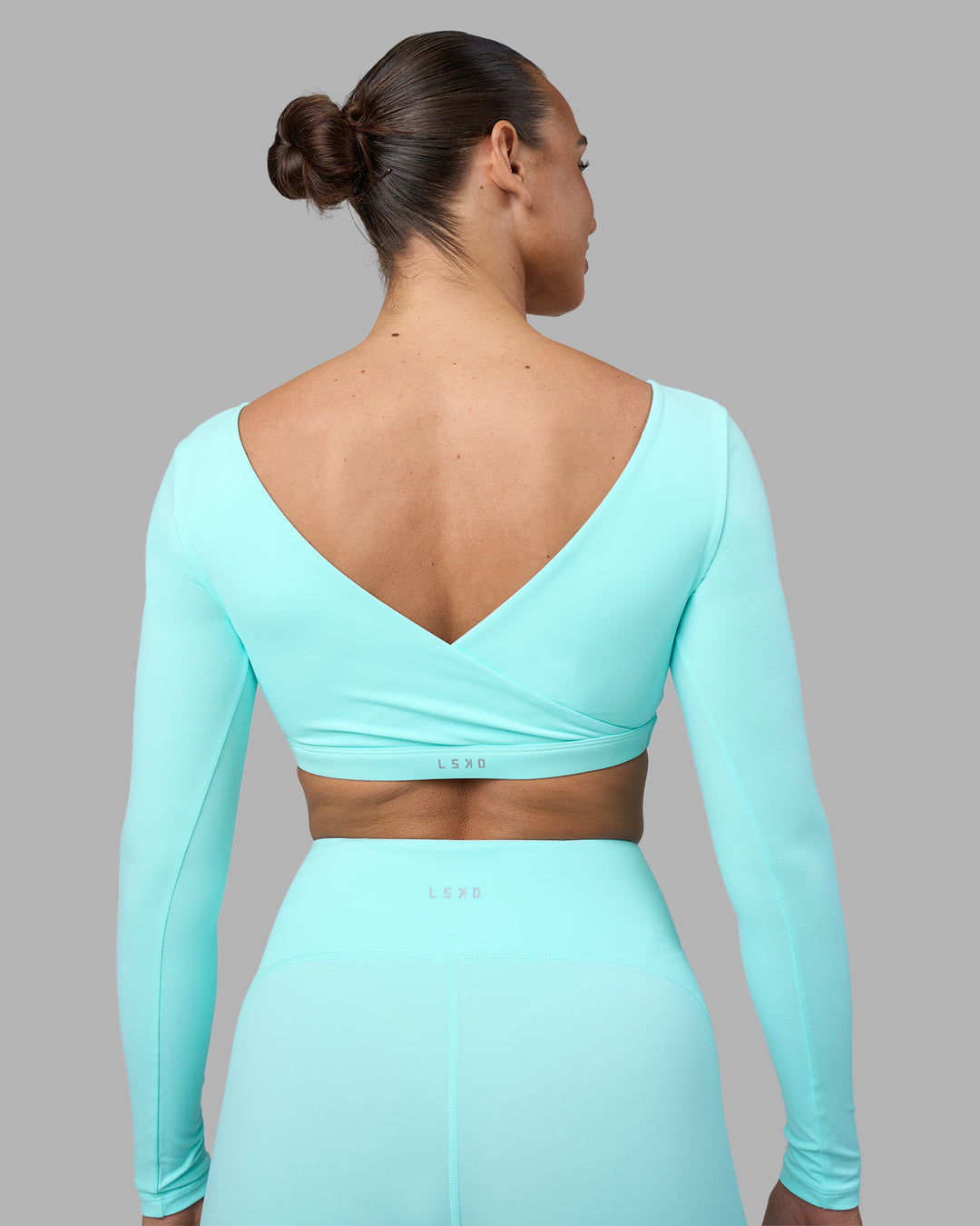 Woman wearing Aria Long Sleeve Sports Bra - Island Paradise | Model:Sophie | Size:S - view 2