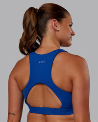 Woman wearing Ascent Sports Bra - Blue Quartz | Model:Phoebe | Size:S | Thumbnail Index: 1