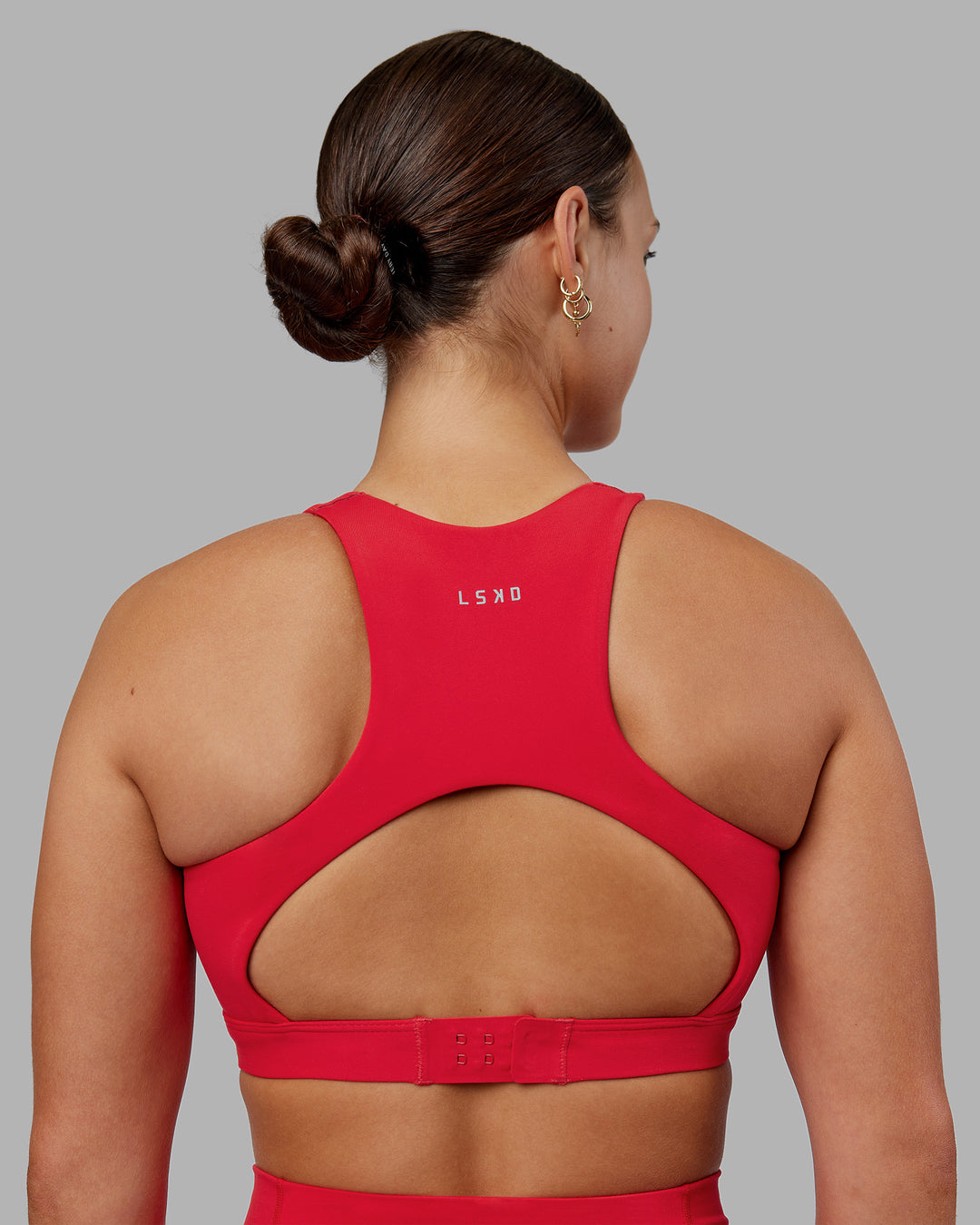 Woman wearing Ascent Sports Bra - Scarlet | Model:Keisha | Size:S - view 2