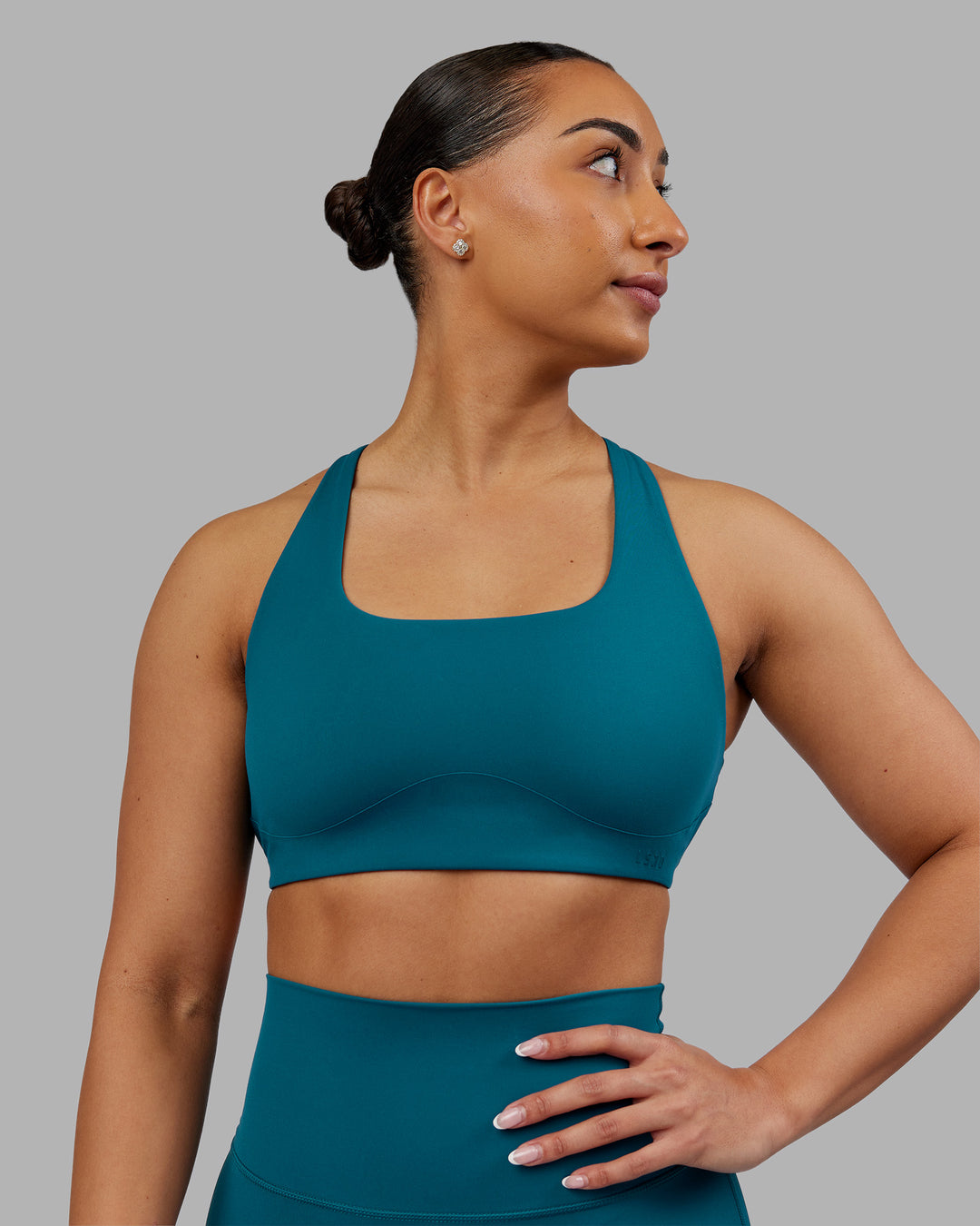 Woman wearing Aspire Sports Bra - Blue Coral | Model:Ayla | Size:S - view 1