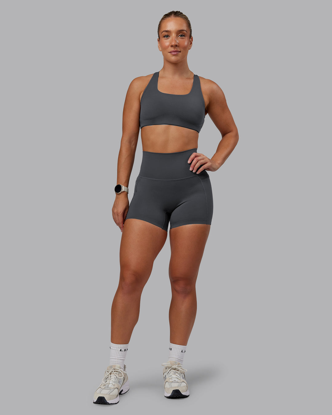 Woman wearing Aspire Sports Bra in Dark Storm | Size:S - view 3