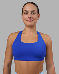 Woman wearing Aspire Sports Bra - Power Cobalt | Model:Keisha | Size:S | Thumbnail Index: 1